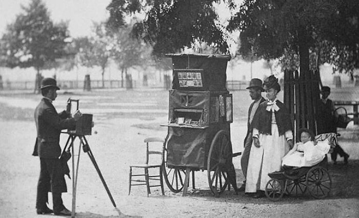 A Family Posing For A Street Photographer , London , 1870s