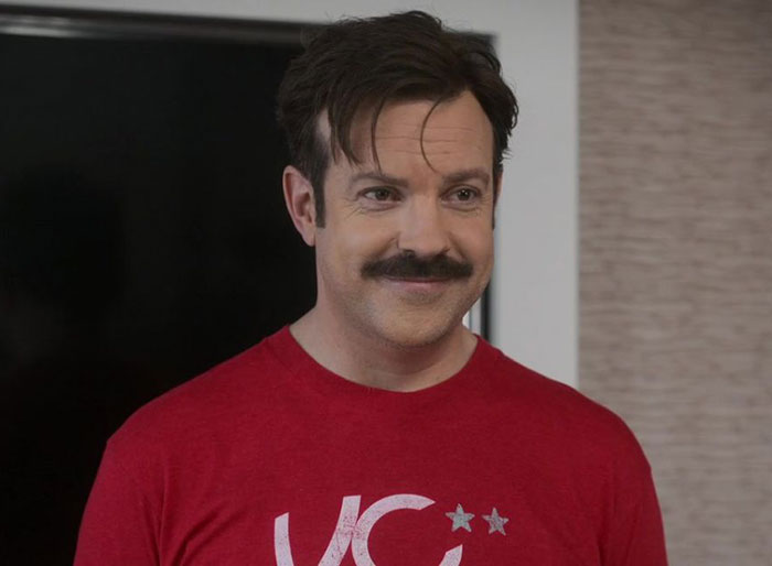 Ted Lasso wearing red shirt