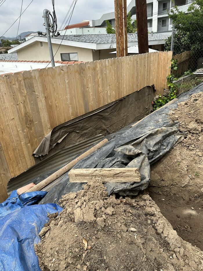 This 6-Foot-High, 50-Foot-Long Dog-Eared Fence Is Serving As An Unconventional Retaining Wall