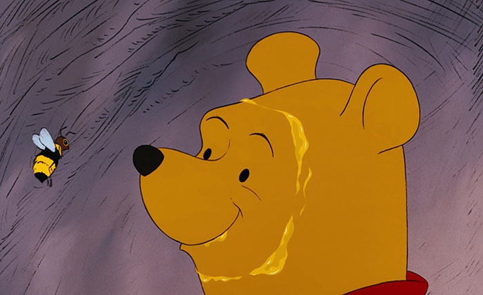 Winnie the Pooh looking at the bee