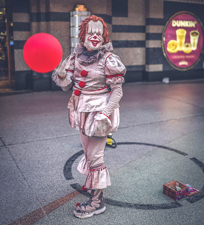 People wearing Pennywise costume