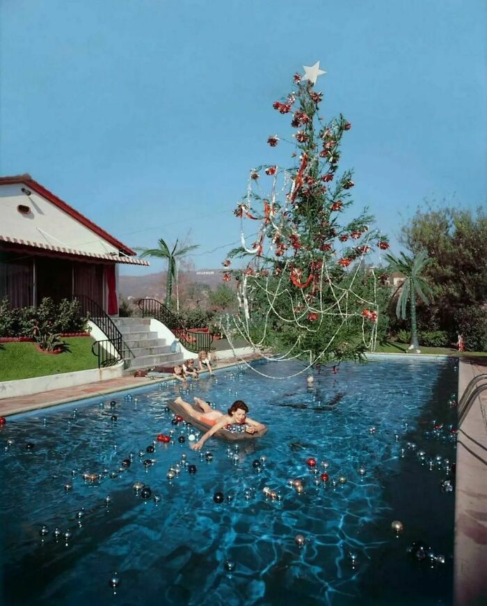 Swimming In A Pool With A Christmas Tree & Floating Ornaments In Los Angeles, 1955. Photo By Slim Aarons