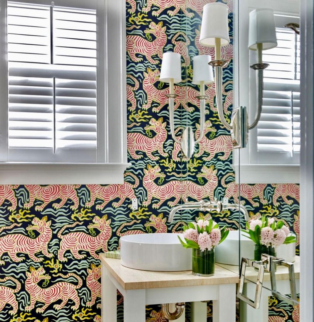 Bathroom with cartoonish tiger wallpaper and sink