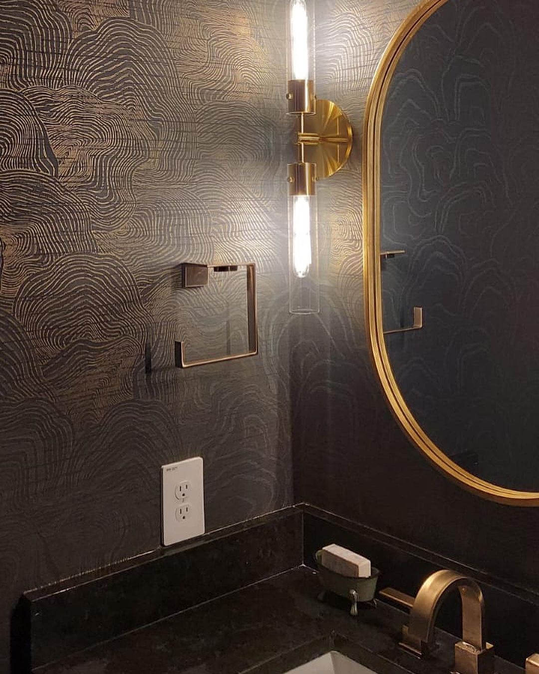 Bathroom with black striped metallic wallpaper and sink