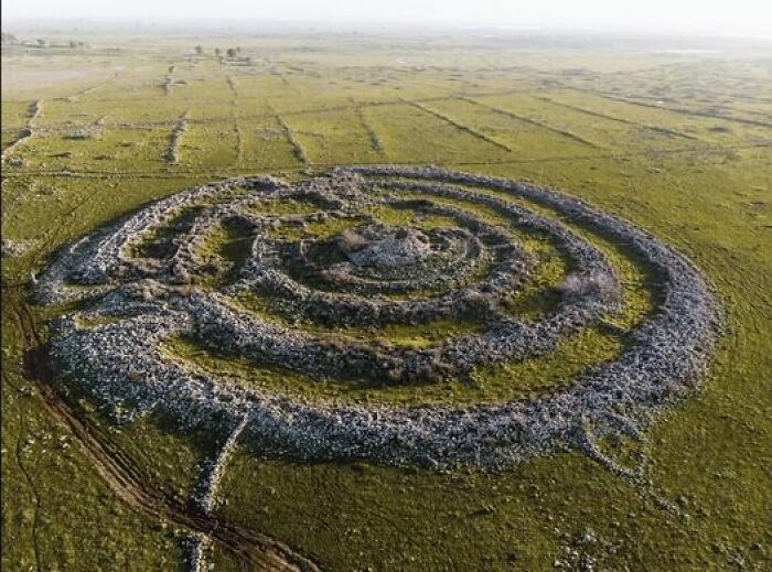 Situated In The Israeli-Occupied Region Of The Golan Heights, Approximately 16 Kilometers East Of The Shores Of The Sea Of Galilee, Rujm El-Hiri Stands As An Awe-Inspiring Ancient Megalithic Structure. This Remarkable Monument Is Comprised Of Concentric Circles Of Stone Encompassing A Central Tumulus. Nestled Within A Vast Plateau Adorned With Numerous Dolmens, Rujm El-Hiri Holds A Captivating Presence In The Midst Of This Picturesque Landscape