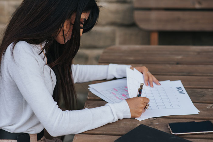 office employee making a schedule at the table