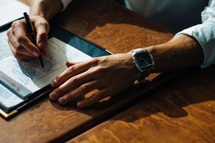 a man making notes into his notebook