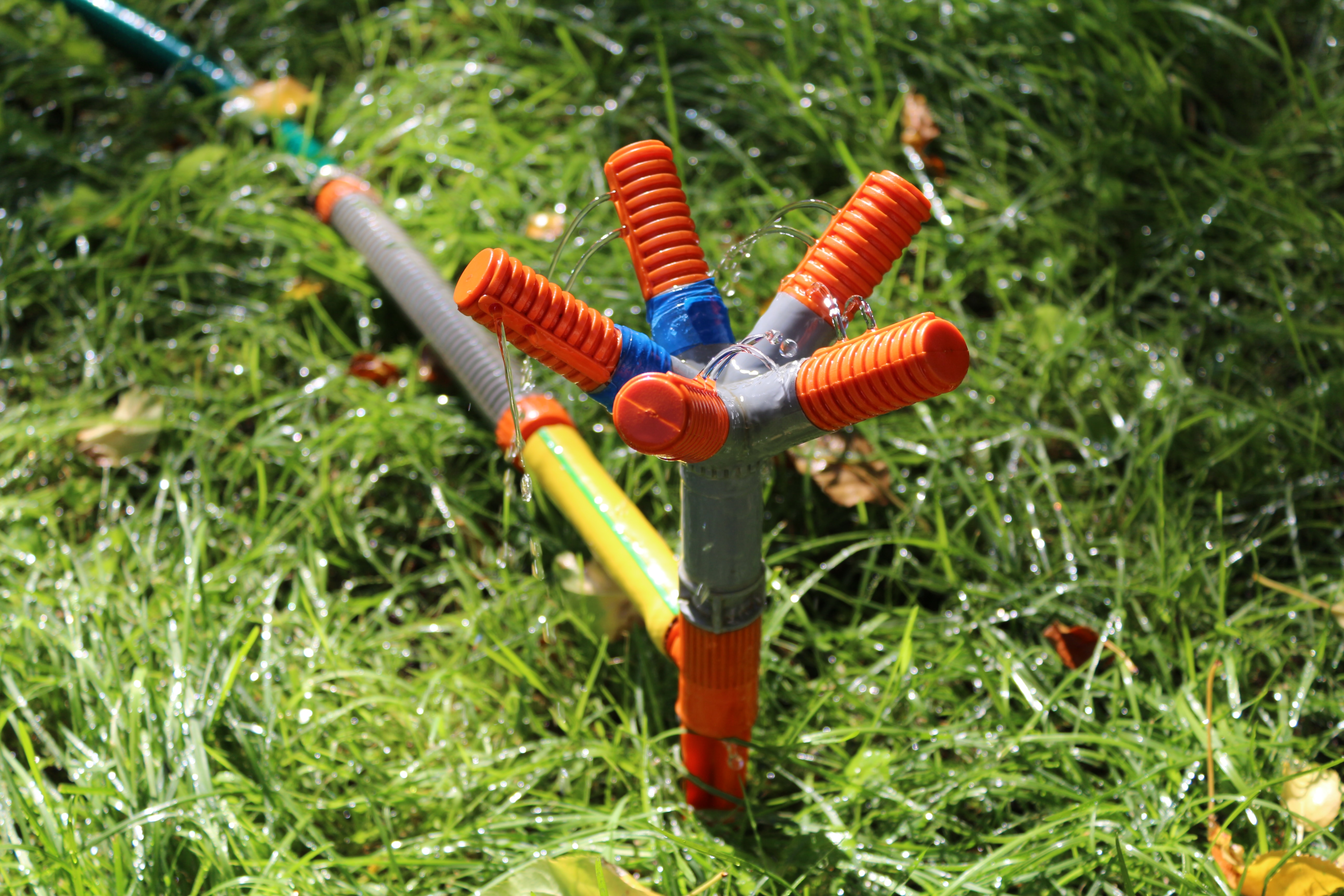 Red and gray sprinkler in the garden