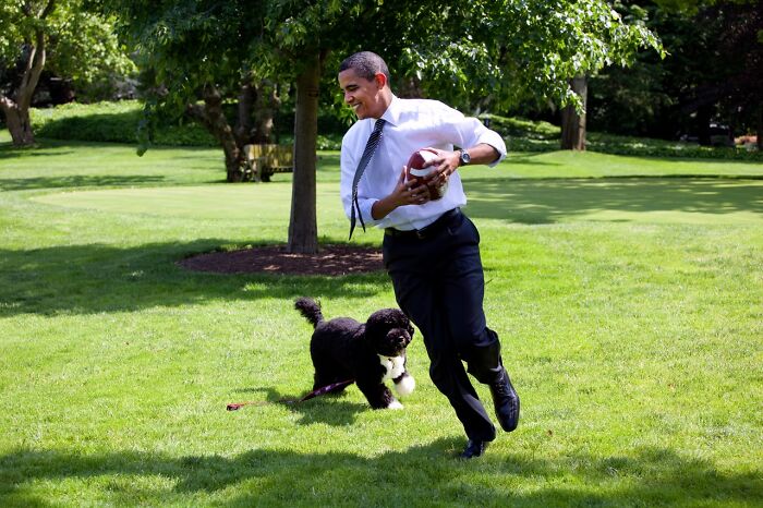 Barack Obama running with dog 