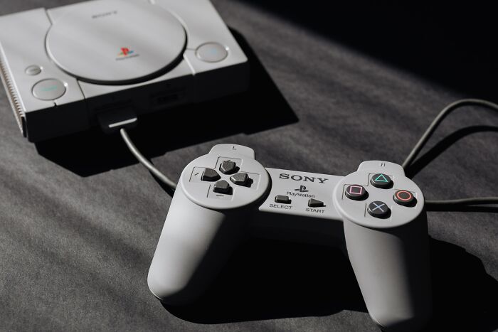 Photo of Play Station Game Console and Remote Controller