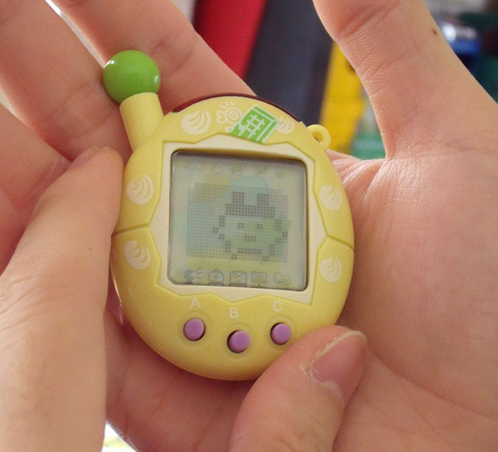 Person holding a Tamagotchi in hands 