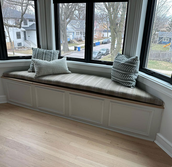 Cozy corner window seat with cushions 