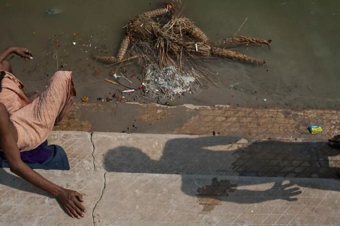 A Photograph Of A Human Sculpture Made Of Hay In Water