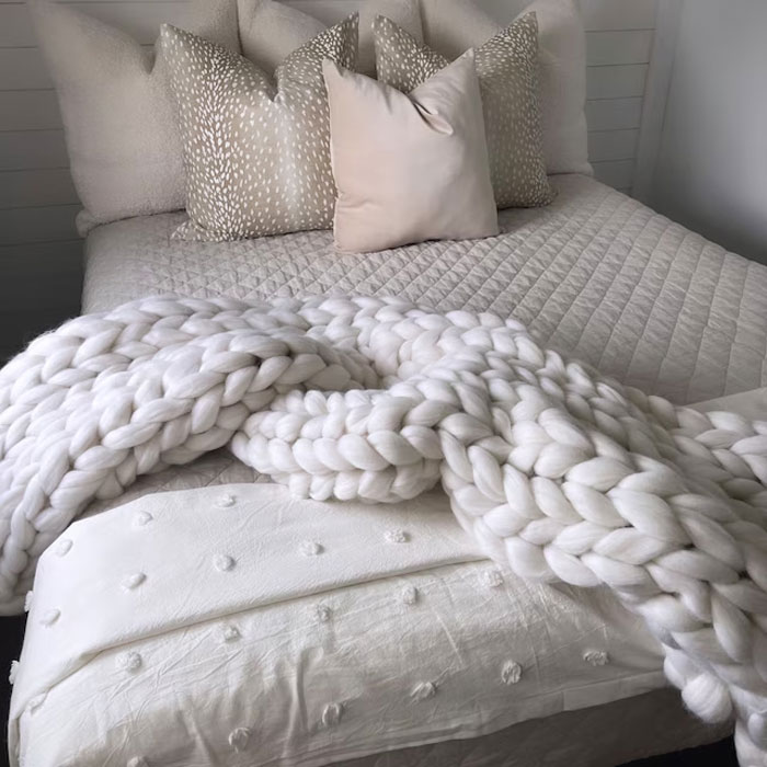 Chunky Knit Blanket: Made from 100% Merino Wool, perfect for creating a warm, cozy atmosphere on chilly nights or as an elegant bed runner.