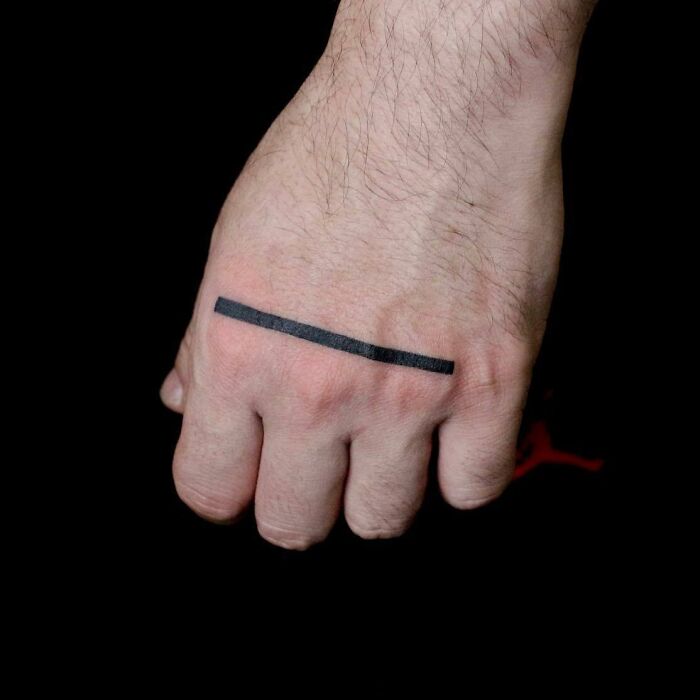 Black thick line tattoo on hand