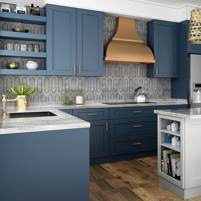Navy and blue kitchen with brass accents and marble countertops by