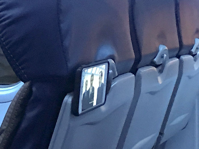 Kid In The Plane Used A Pop Socket To Hold His Phone On The Seat In Front Of Him