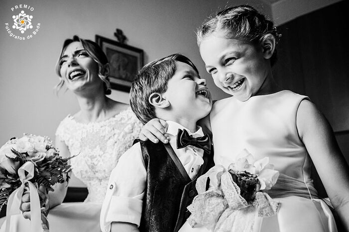 Bride laughing with two children in joyful wedding moment, showcasing incredible wedding photography.