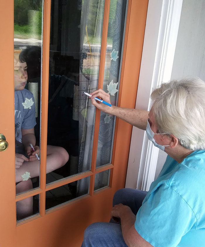 So My Mom (67) And My Nephew (12) Can't Spend Time With Each Other Because Of The Pandemic. So Today Mom Grabbed A Mask And Headed Over For Some Fun And Games Through The Door