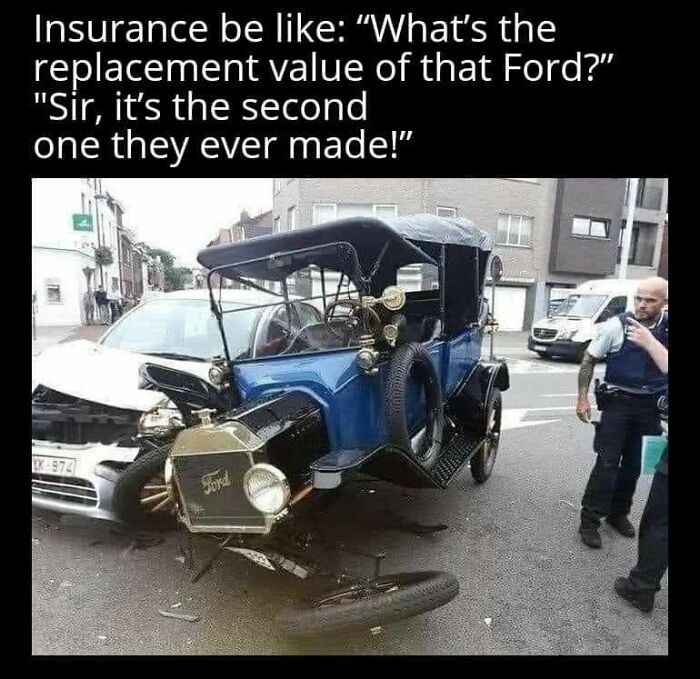 Broken vintage Ford vehicle after a costly-looking accident with a white car, being inspected by police officers.