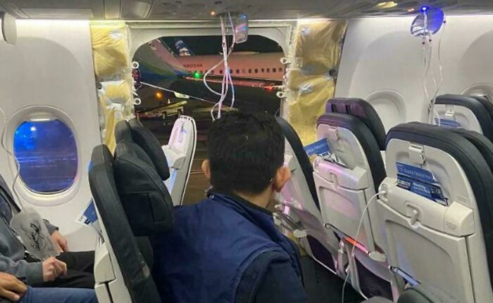 Airplane cabin with damaged section exposing another aircraft, highlighting an unfortunate incident that looks expensive.