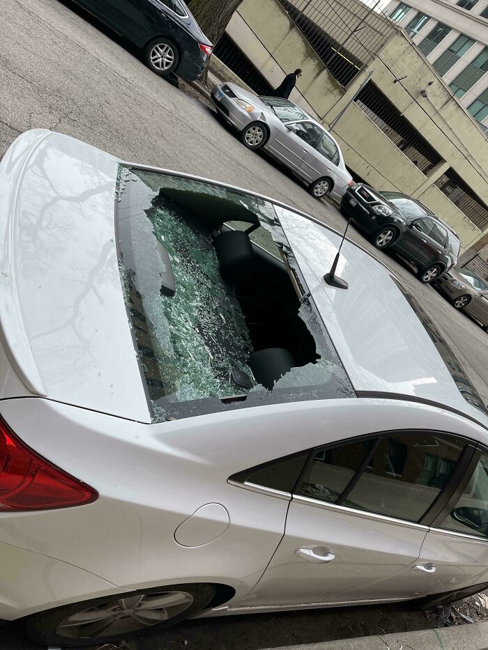 Damaged car with smashed rear window, illustrating an expensive incident.