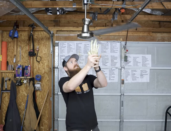 Youtuber Testing A Unsecured Ceiling Fan With Sharpened Blades While Standing Underneath It And Using His Hands