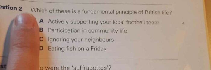 Quiz sheet with options on British life principles, including football support and eating fish on Fridays; finger pointing at option A.