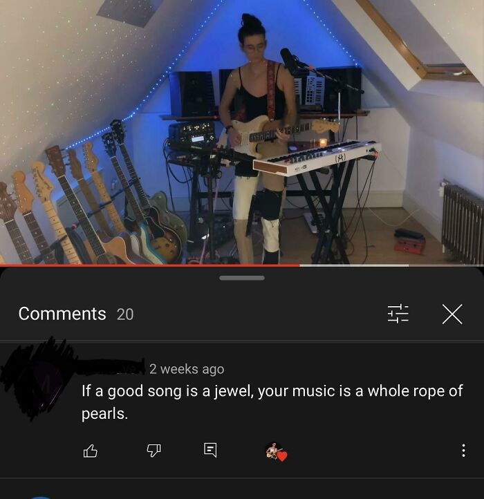 Musician playing guitar in studio with rare compliment about their music being a &ldquo;rope of pearls&rdquo; visible in comments.