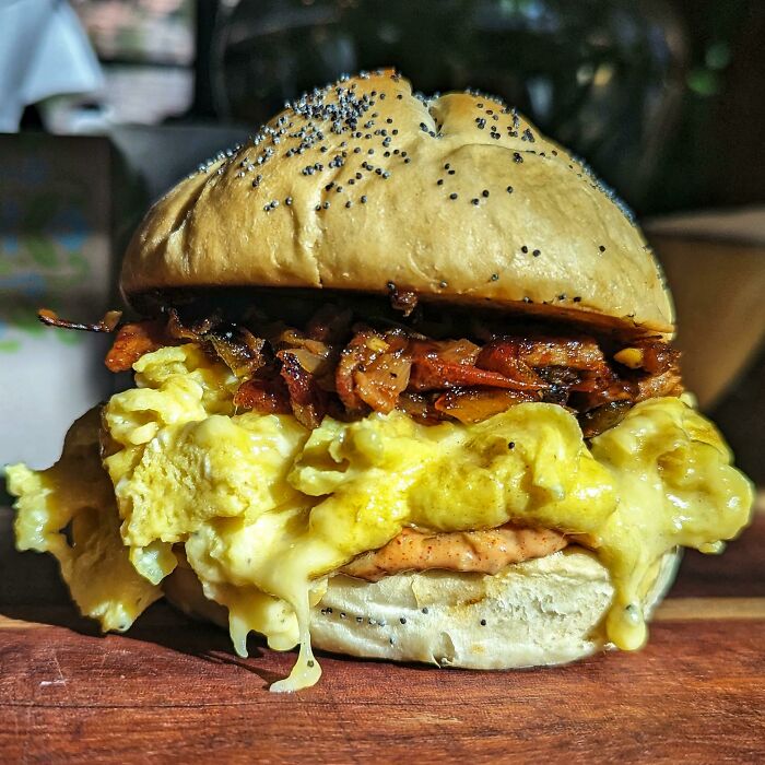 Breakfast Sandwich: Fresh Kaiser Roll, Egg, Truffle Gouda, Hickory Smoked Bacon, Caramelized Onions, Roasted Jalapenos & Tomatoes, And Pub Sauce