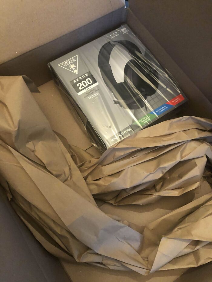 Oversized box with a small headset package inside, illustrating poor product packaging.