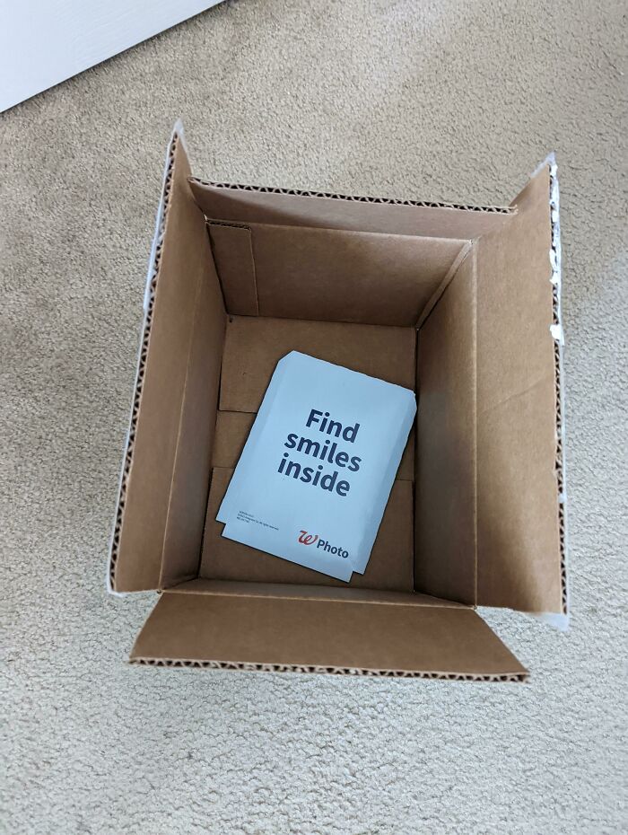 Empty cardboard box with misleading packaging message, "Find smiles inside," highlighting a wrong product packaging example.