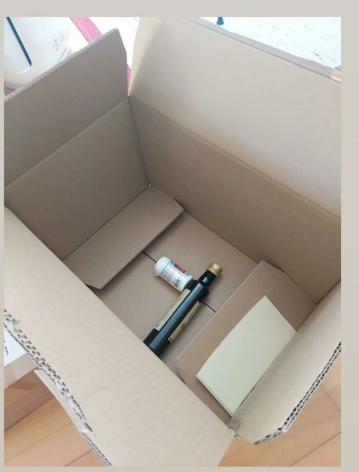 Excessive packaging with small items in a large cardboard box, highlighting poor product packaging design.