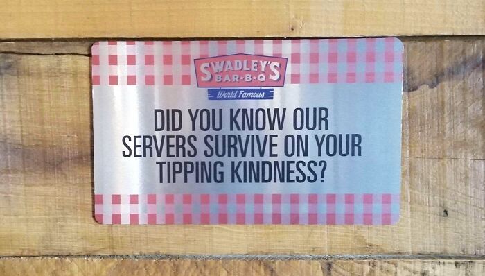 Sign at Swadley's Bar-B-Q humorously highlights the importance of tipping, showcasing peak dumb moments in American culture.