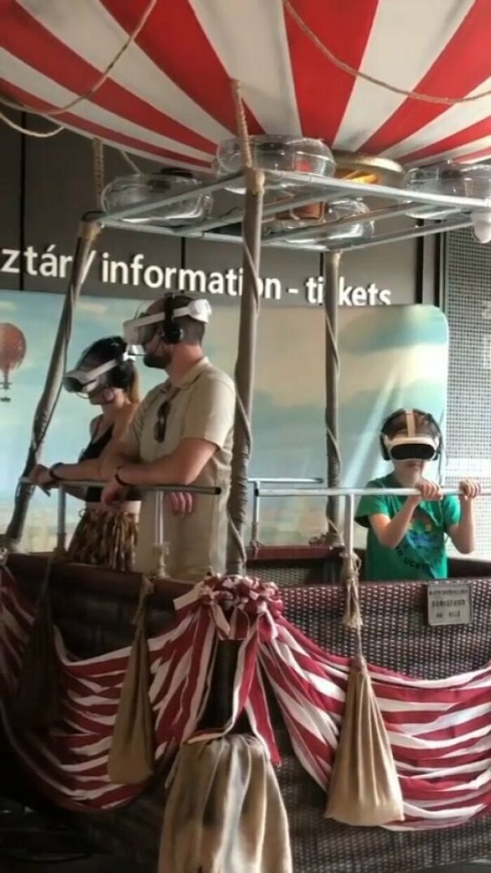 People using virtual reality headsets in a hot air balloon basket, showcasing humans of capitalism experiences.