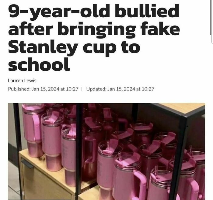 Pink Stanley cups displayed on a shelf.