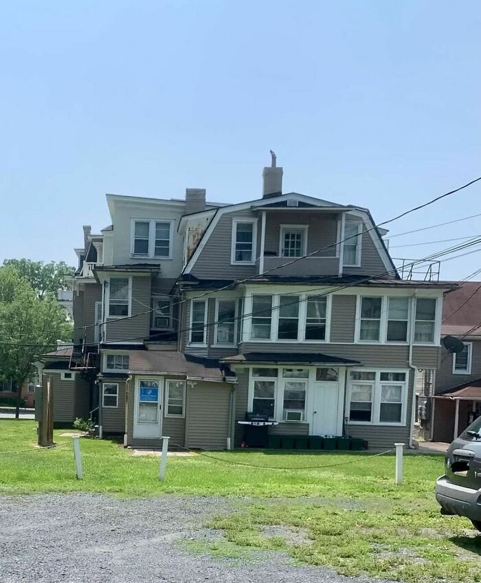 A multi-story house with awkward extensions showcasing a design disaster in residential architecture.