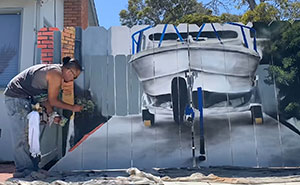 City Forces Guy To Build A Fence To Hide His Boat, He Complies Maliciously And Paints A Mural On It