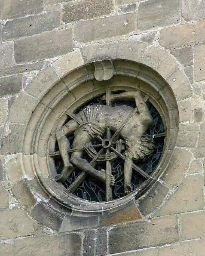 A Window In St. George’s Collegiate Church In Tübingen, Germany, Depicts A Medieval Execution On The Catherine Wheel