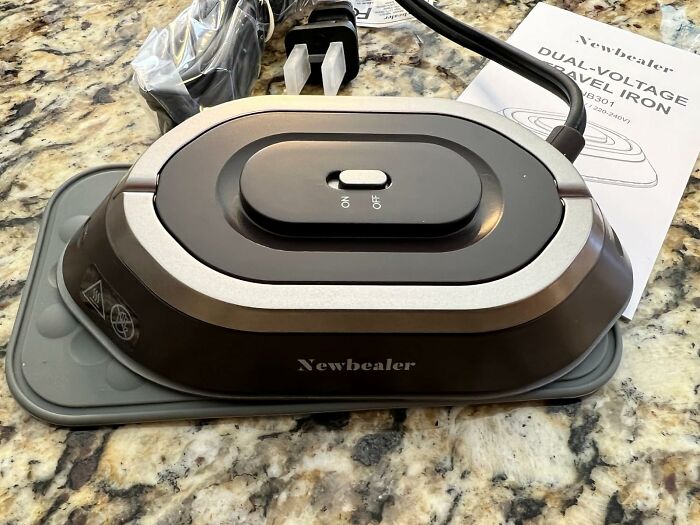 This Travel Iron Is Compact And Comes With A Heat-Resistant Pad So You Don't Burn Down Your Hotel Room
