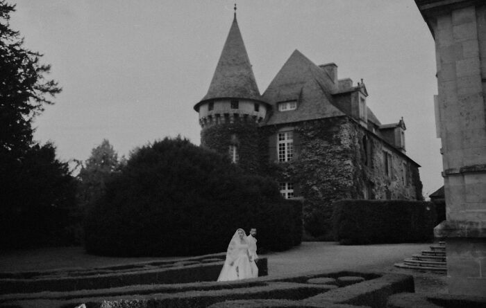 Bride and groom in front of a stone castle, showcasing top destination wedding photography.