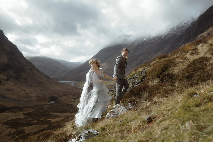 Couple in wedding attire on a scenic mountain landscape, capturing the essence of destination wedding photography.