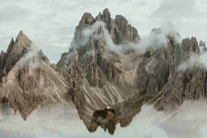 Couple on mountain peak surrounded by mist, showcasing one of the best destination wedding photos of 2024.