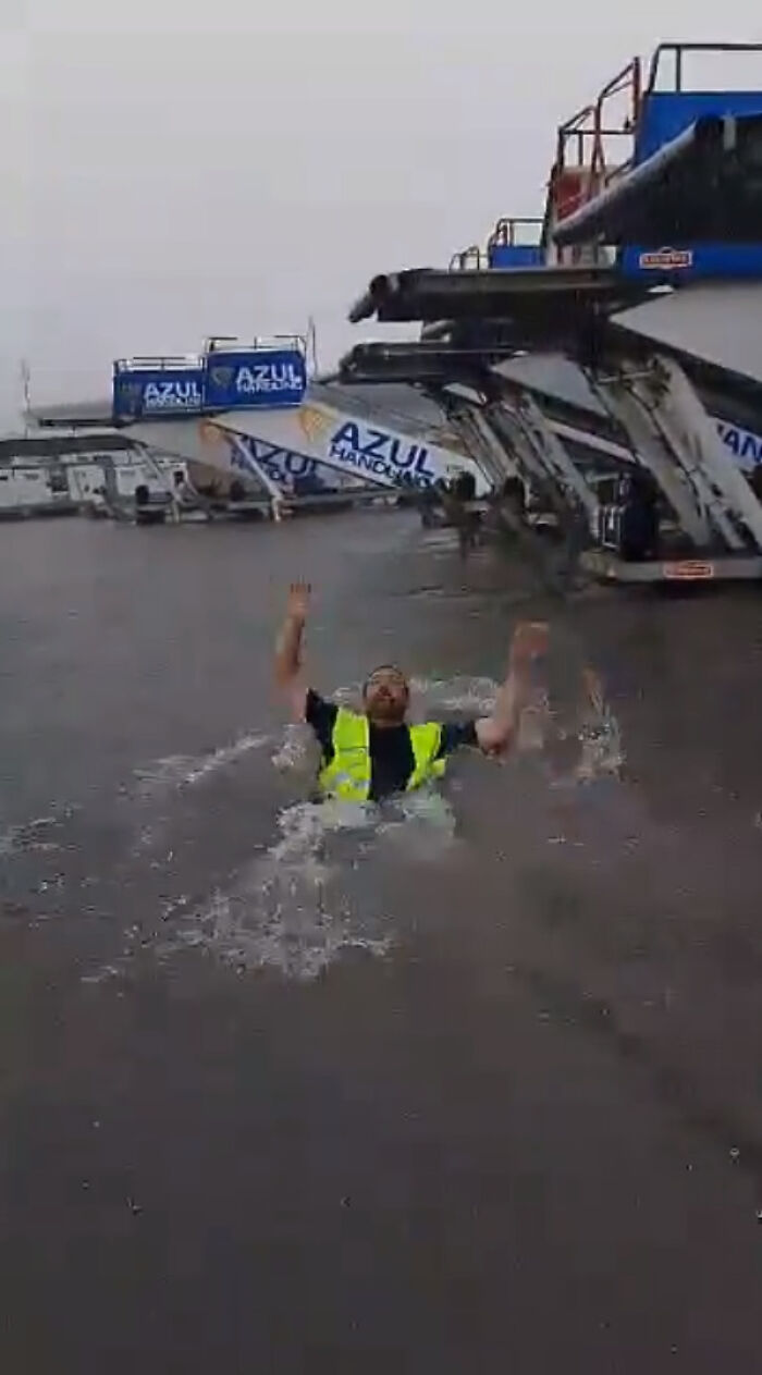 After Airport Floods, Hilarity Ensues As Workers Clean Up Water With Brooms, Swim On The Tarmac