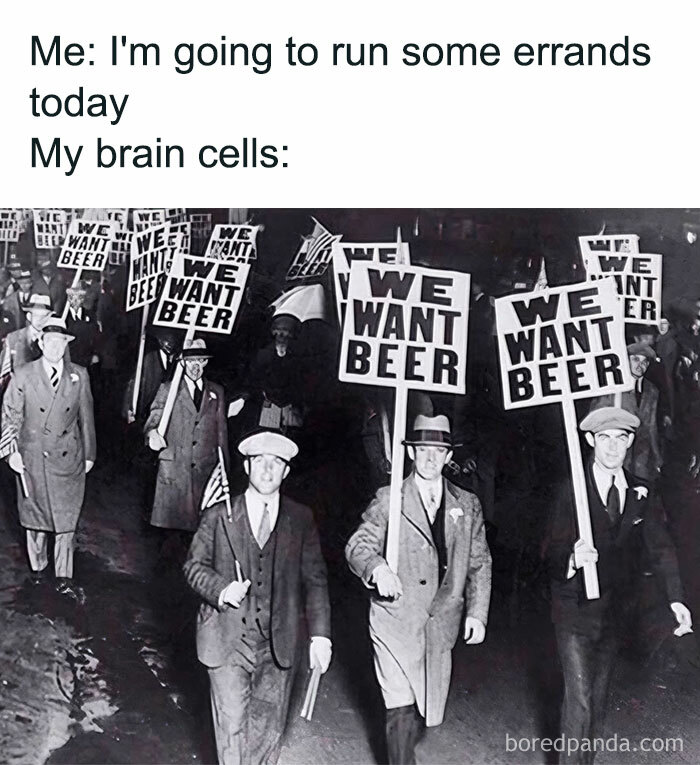 Men in suits holding signs saying "We want beer" for Friday meme.
