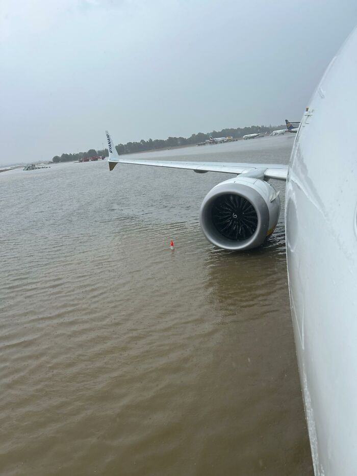 After Airport Floods, Hilarity Ensues As Workers Clean Up Water With Brooms, Swim On The Tarmac