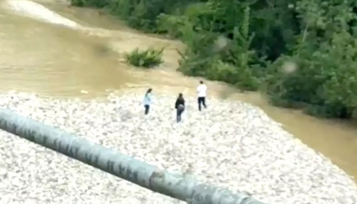 Footage Shows Three Friends In Final Hug Moments Before Being Swept Away In Flood