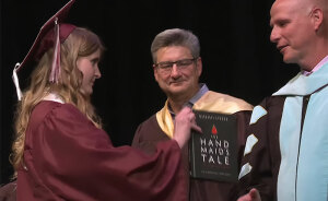 High School Graduate Refuses To Shake Superintendent’s Hand And Offers Him Banned Book On Stage