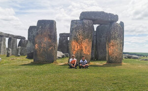 Stonehenge Spray-Painted Orange In Broad Daylight As Onlookers Try To Hold Back Vandals