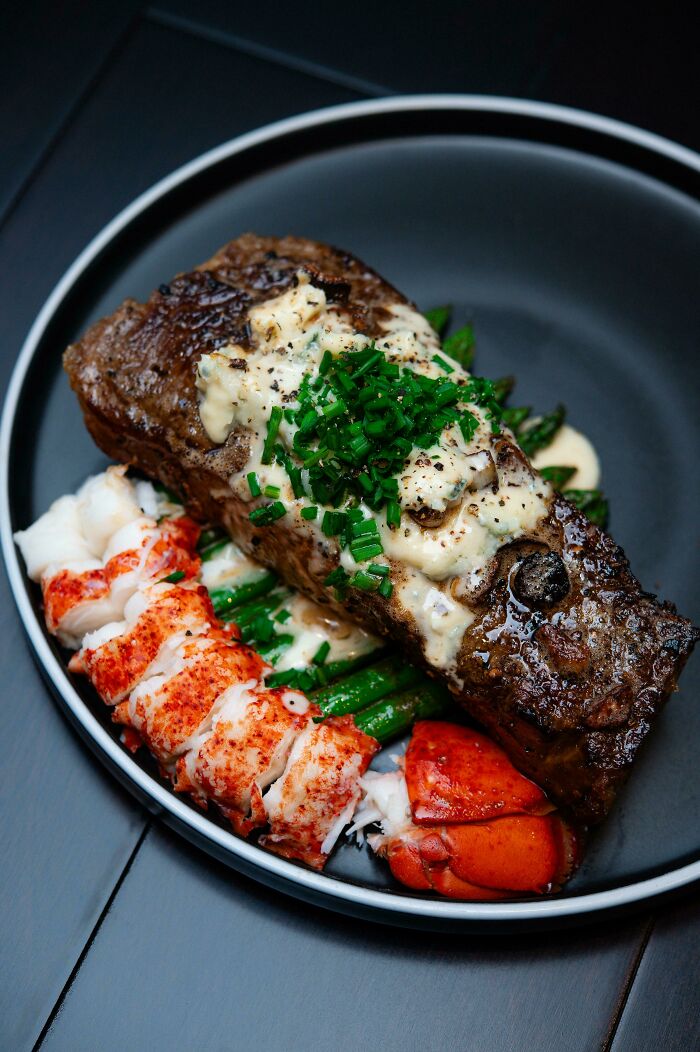 Homemade Surf And Turf With Blue Cheese Pepper Sauce On Buttered Asparagus